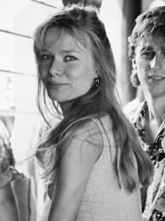 A candid black-and-white photo of Jane Perlmutter smiling warmly at a family gathering