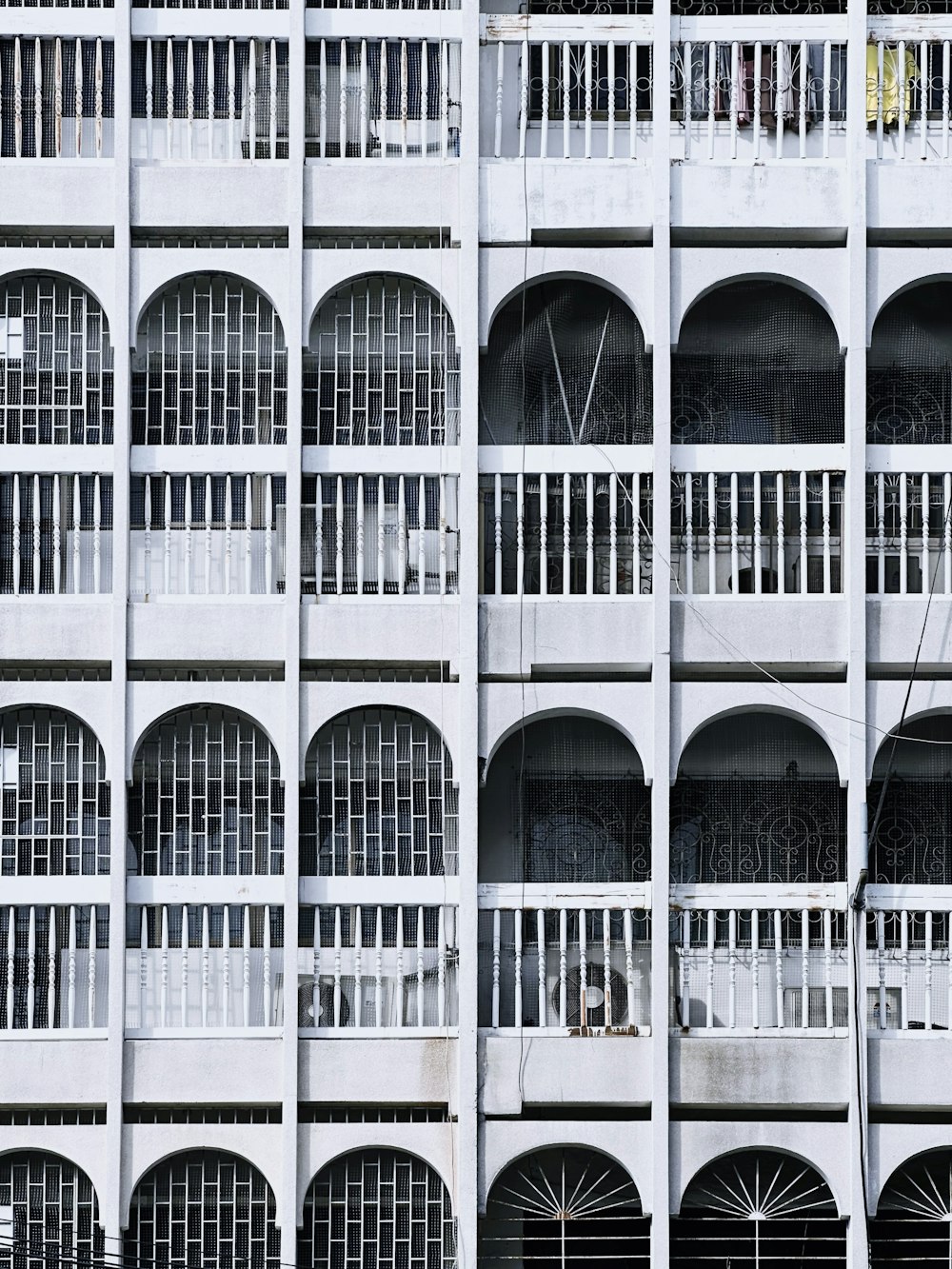 a tall white building with lots of windows