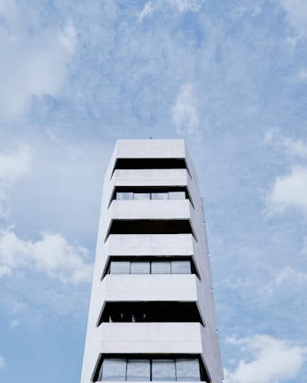 The Royal Costa Tower standing tall under a clear blue sky, highlighting its clean lines and glass façade.