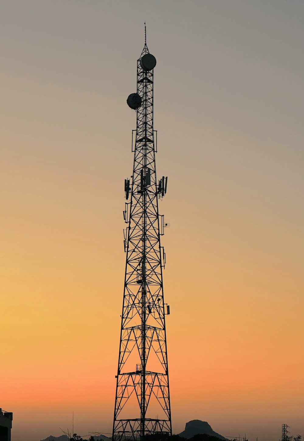 a tall tower with a cell phone on top of it