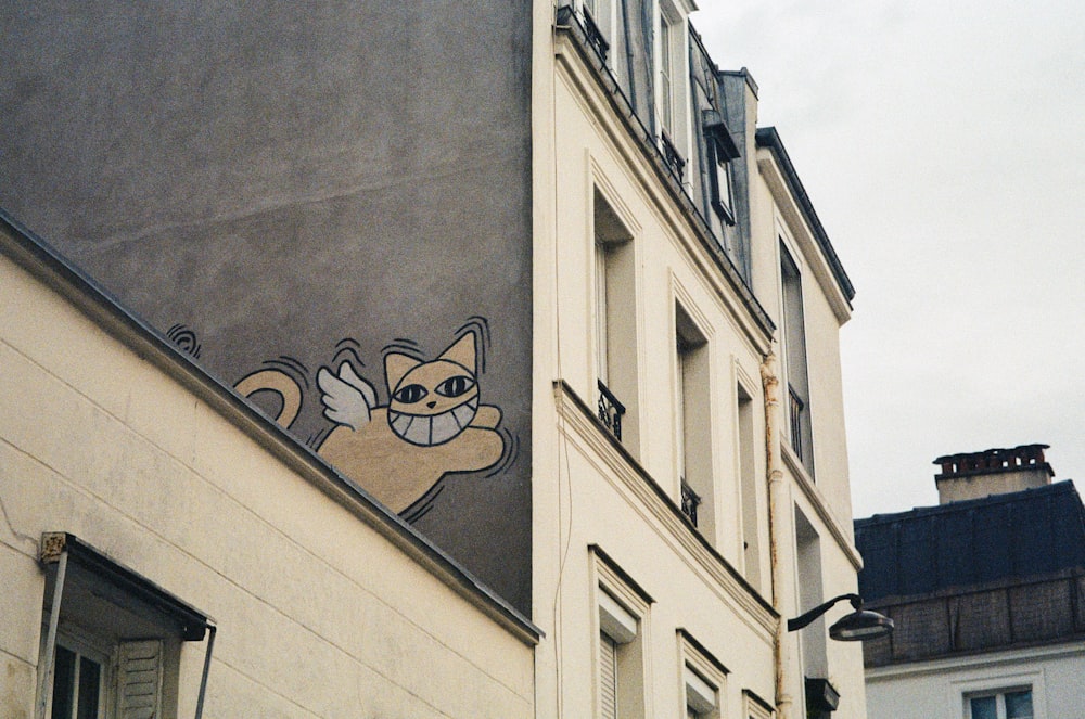 a picture of a cat on the side of a building