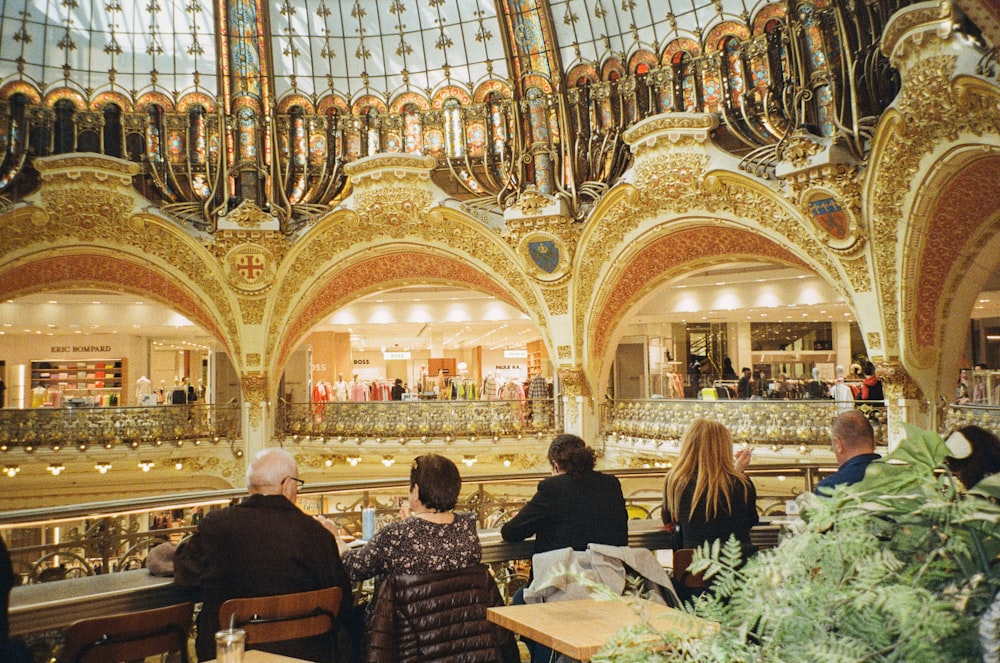 a group of people sitting at tables in a restaurant