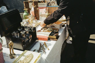 Close-up of hands bidding on vintage furniture at an auction event