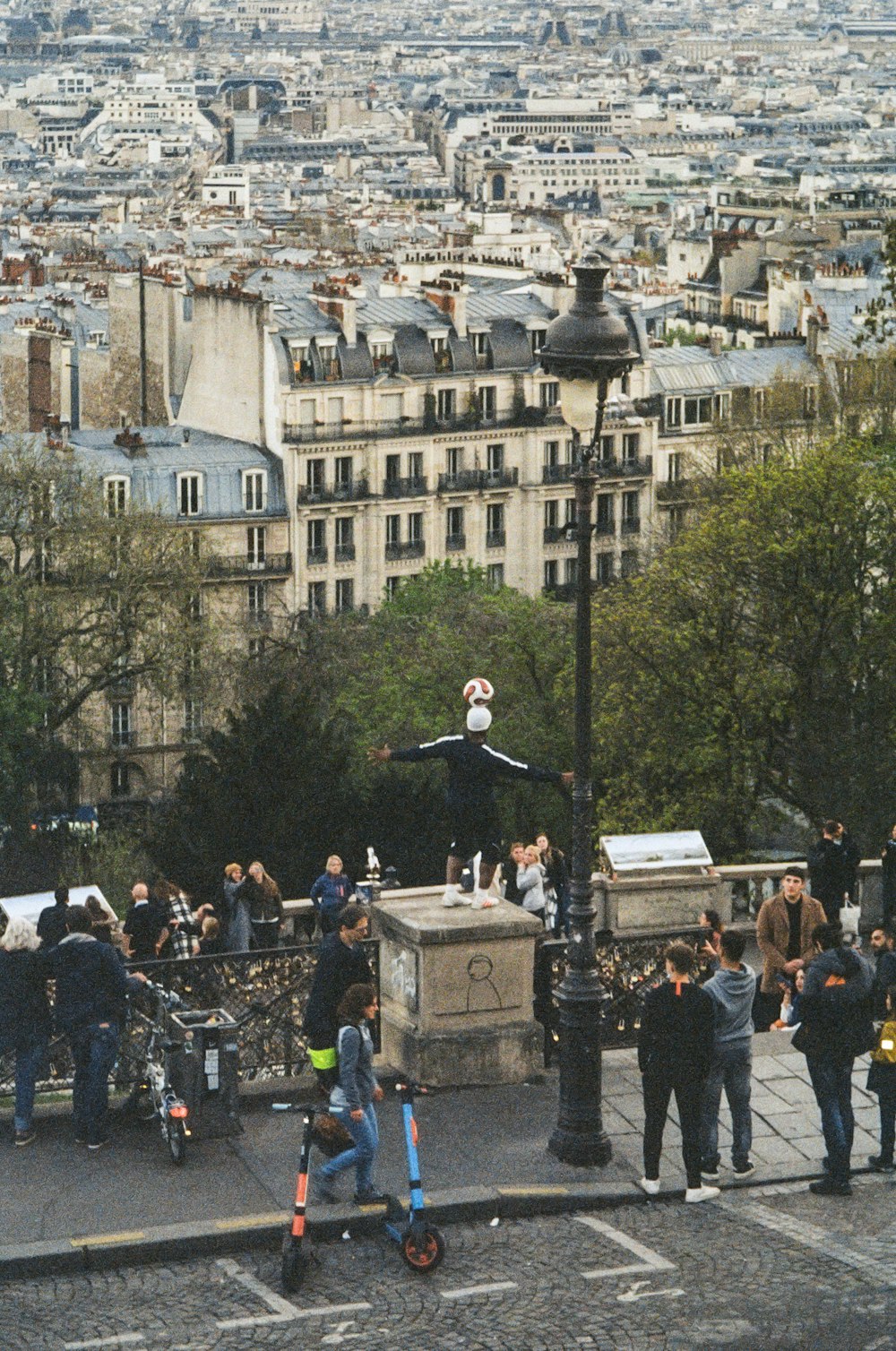 a group of people standing on top of a street