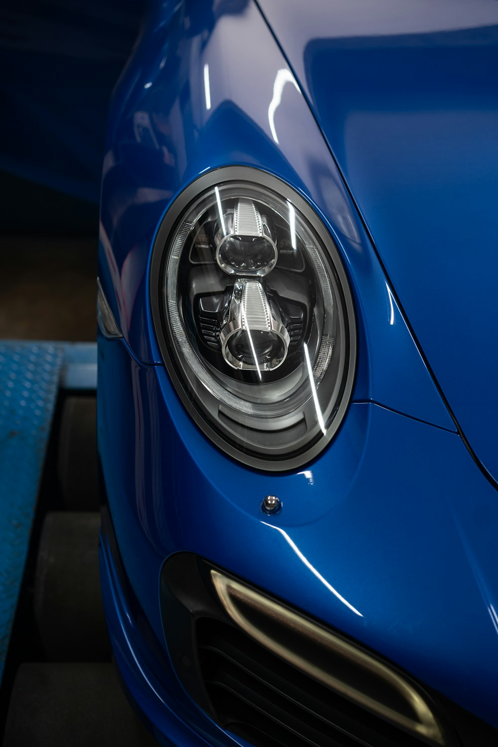 a close up of the front of a blue sports car