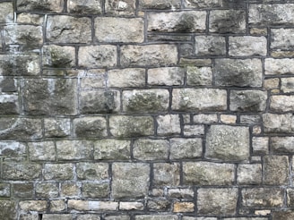 Wide shot of a rustic stone wall rebuilt with warm southern tones.