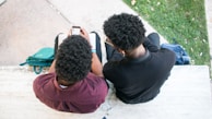 a couple of people sitting on top of a bench