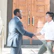 Man shaking hands with a lawyer in a bright, green-themed office.