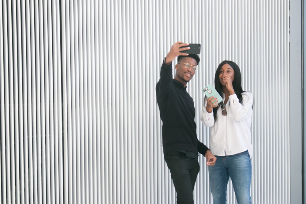 a man taking a picture of a woman with a camera