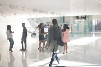 a group of people standing around in a building