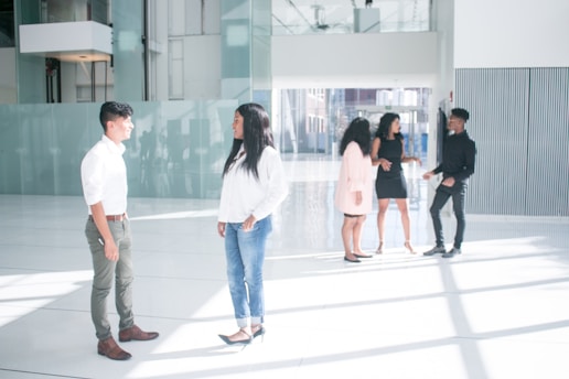 A property manager discussing plans with a team in a well-maintained apartment lobby.