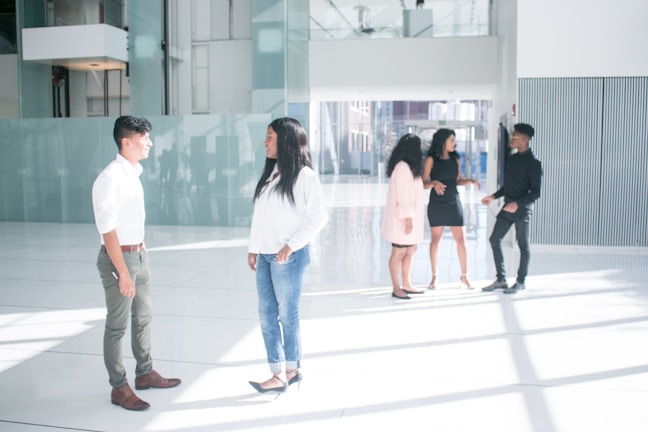 Team discussing energy efficiency improvements inside a building lobby.