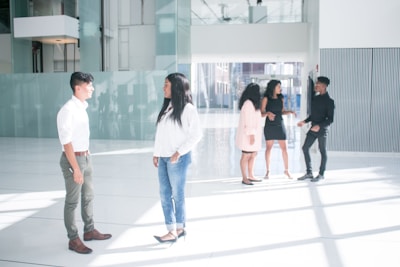 A group of diverse individuals discussing financial options in a bright, inviting bank environment.