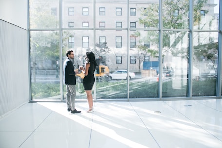 A real estate agent discussing property options with clients in a bright, open setting.