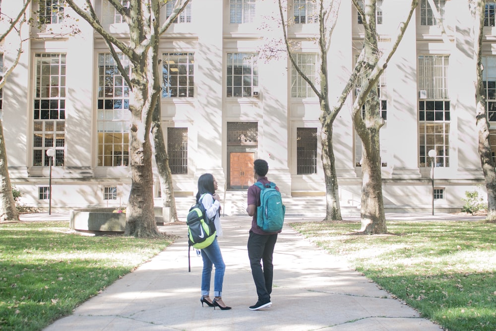 a couple of people that are standing in front of a building