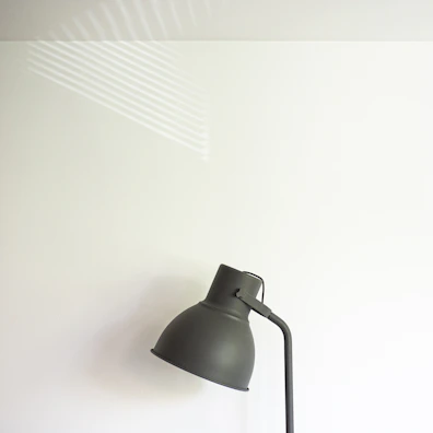 Close-up of a sleek hongrui projector light casting a warm glow on a minimalist wall.