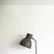Close-up of an abstract design lamp casting artistic shadows on a minimalist wall.