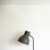 Close-up of the Orbian lamp casting warm shadows on a cream-toned wall in a minimalist living room.