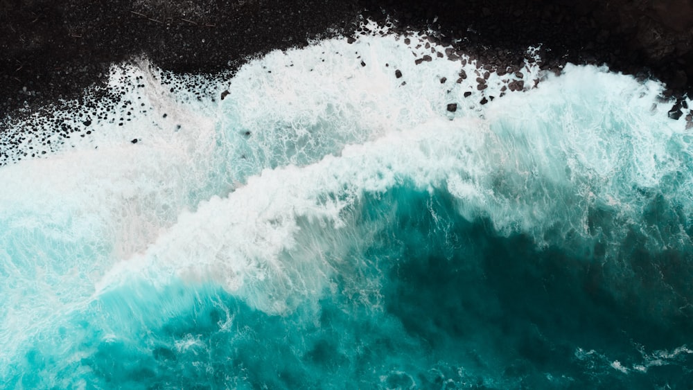 a large body of water with waves crashing against it