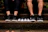 A close-up shot of a young couple wearing matching Northpair sneakers, smiling and walking side by side on a city street.
