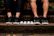 A close-up shot of a young couple wearing matching Northpair sneakers, smiling and walking side by side on a city street.