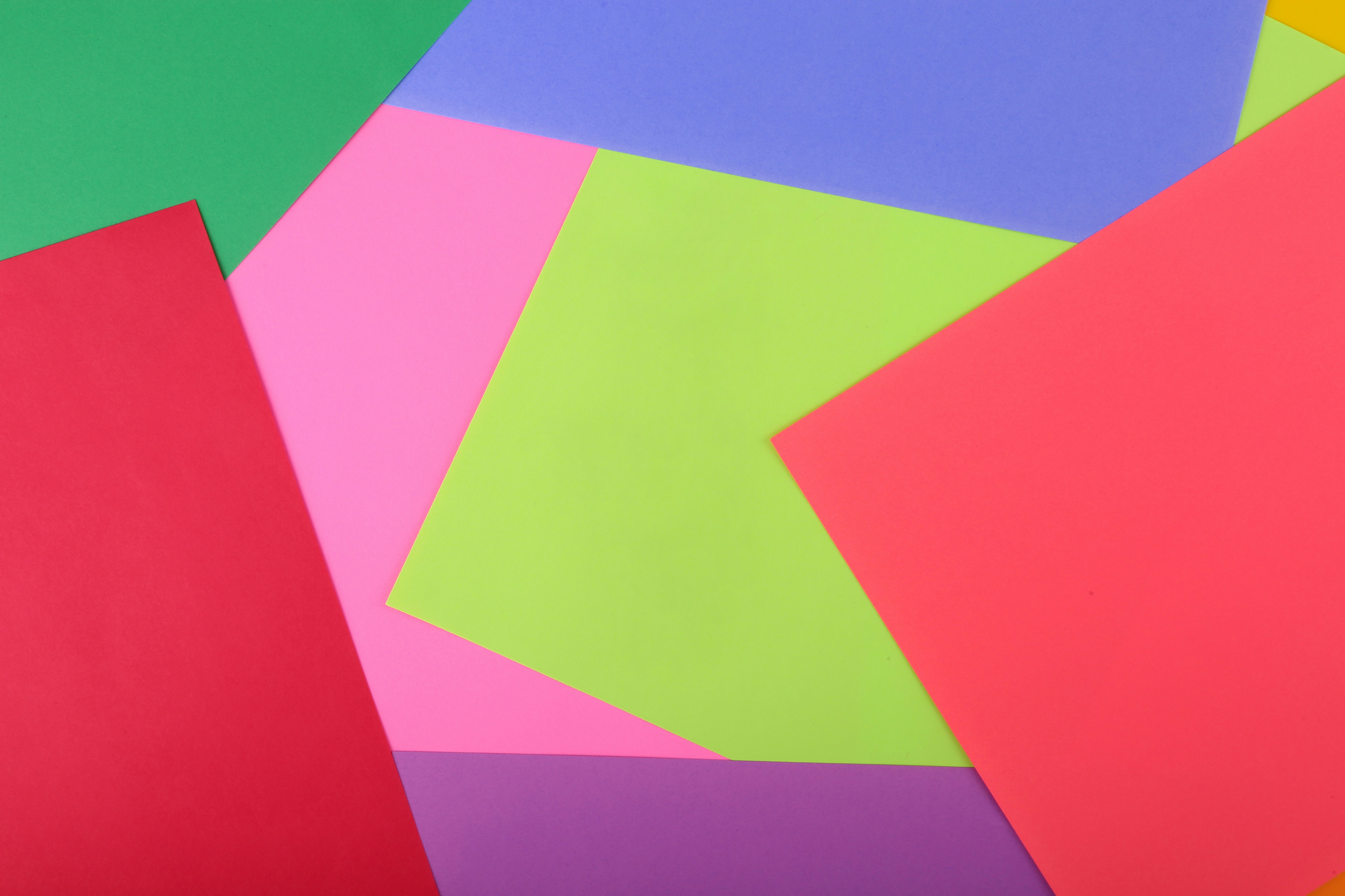 a bunch of different colored papers stacked on top of each other