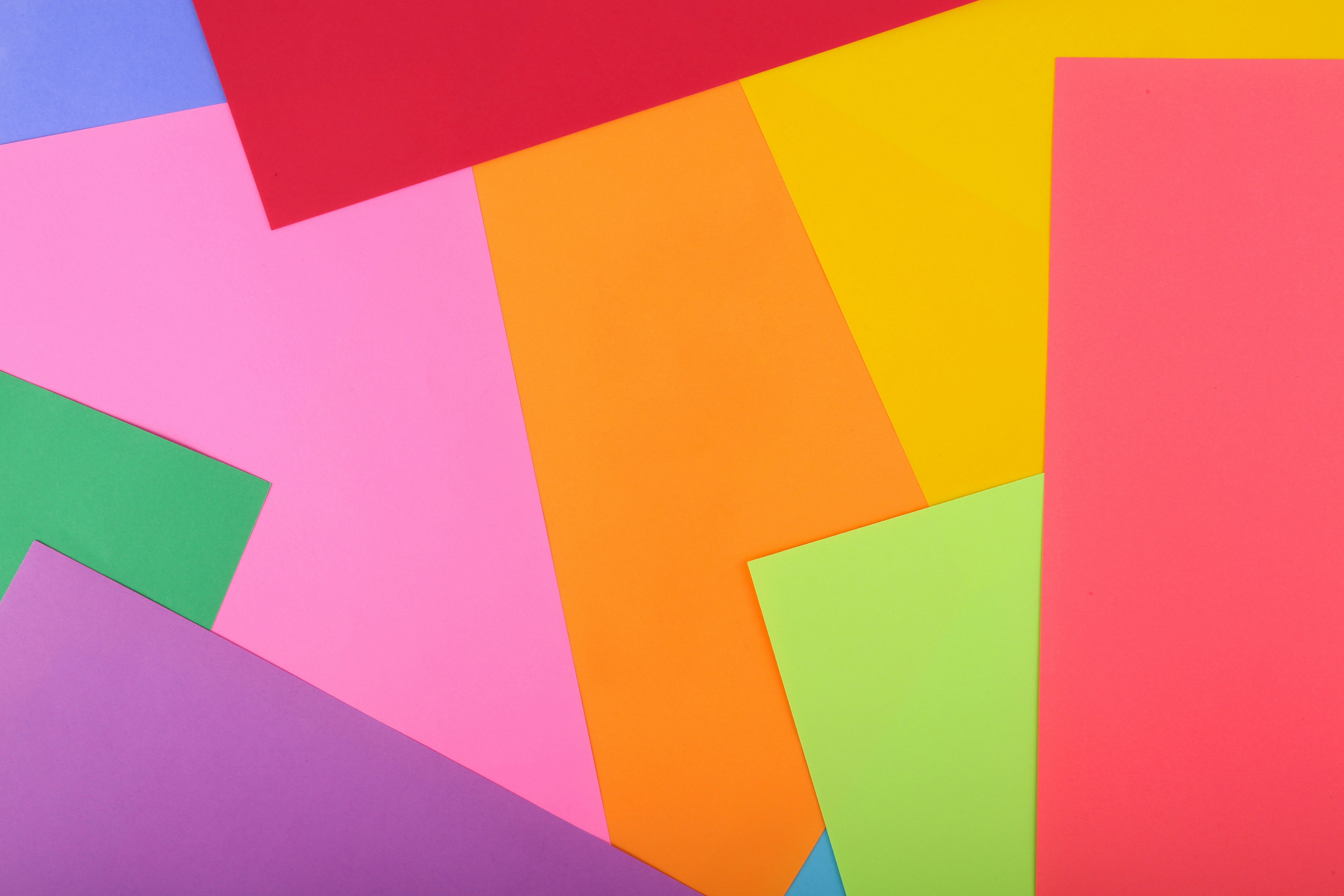 a bunch of different colored papers on top of each other