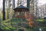 A neatly assembled wooden gazebo in a sunny backyard.