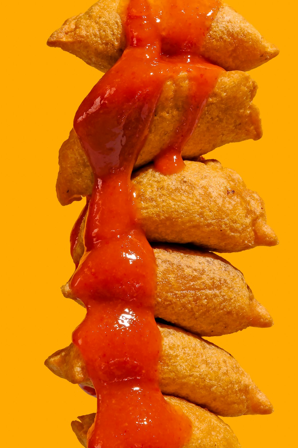 a stack of pastries covered in ketchup
