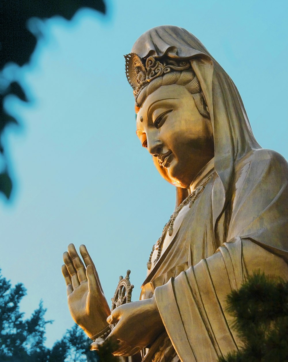 a statue of a woman with her hands together