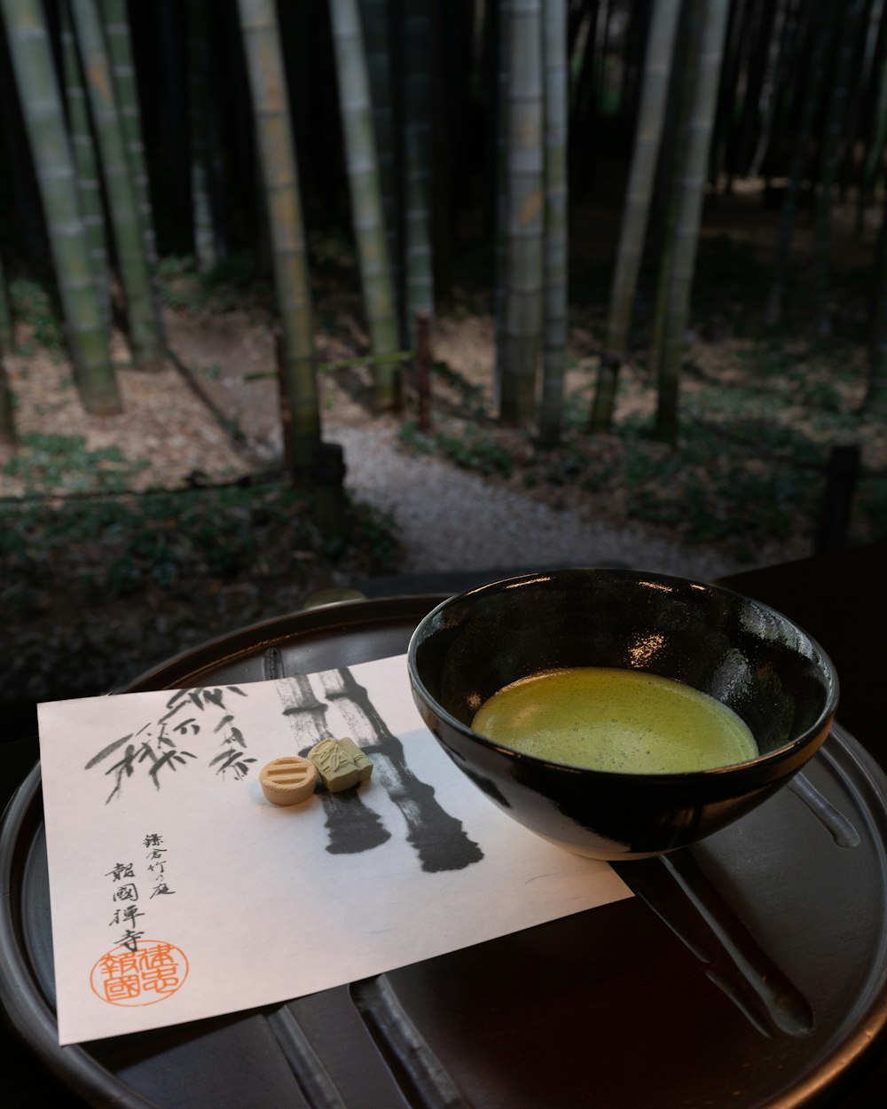 a bowl of soup sitting on top of a wooden table