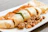 Close-up of a juicy special kathi roll with fresh vegetables and spices.