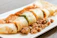 Close-up of a juicy special kathi roll with fresh vegetables and spices.