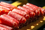 a close up of a bunch of meat on a cutting board