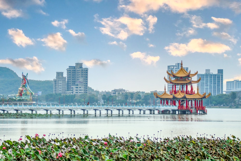 a large red and yellow building sitting on top of a lake