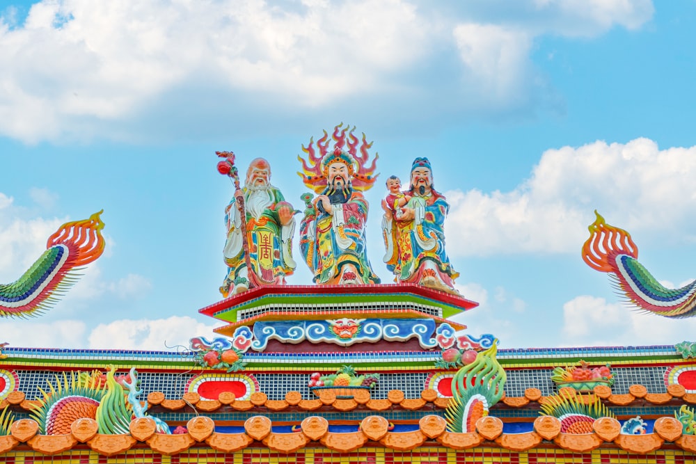 a colorfully decorated roof with statues on top