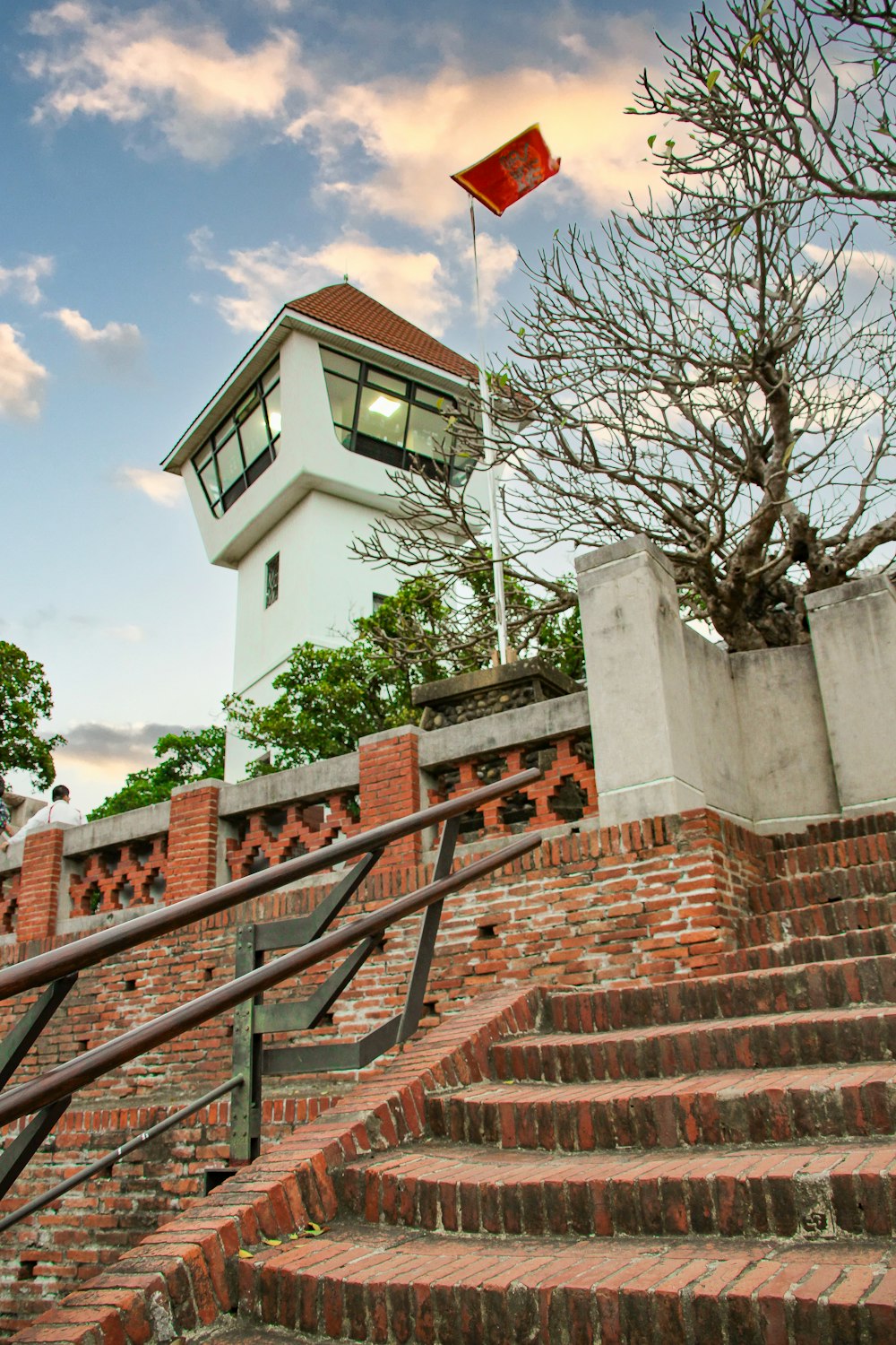 a red brick staircase leading to a light house