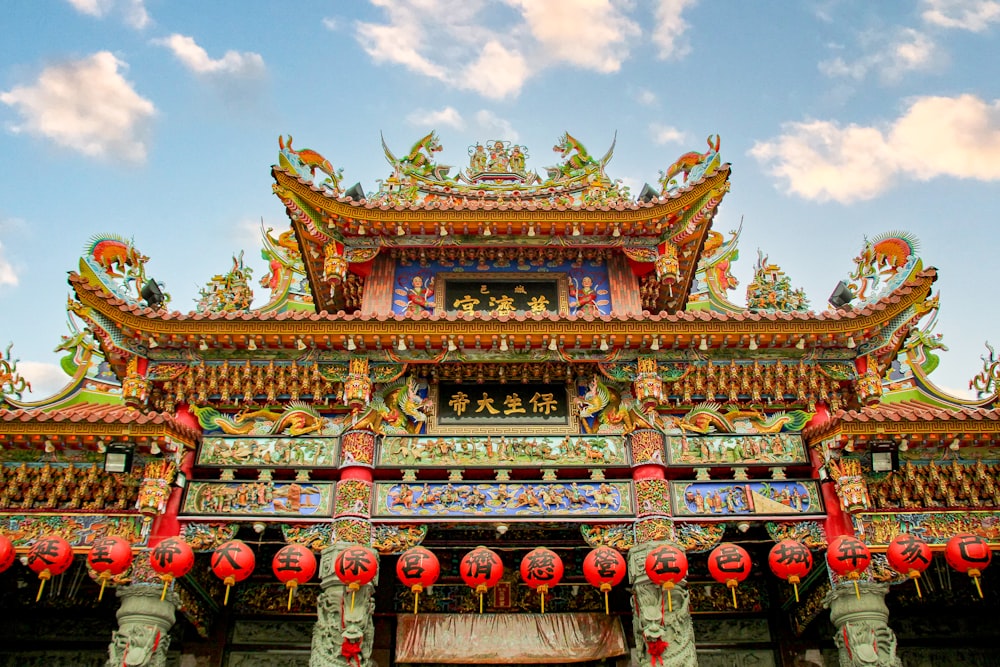 a chinese building with red lanterns hanging from it's roof