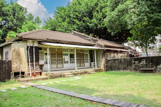 an old house with a wooden walkway leading to it