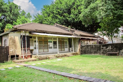 an old house with a wooden walkway leading to it