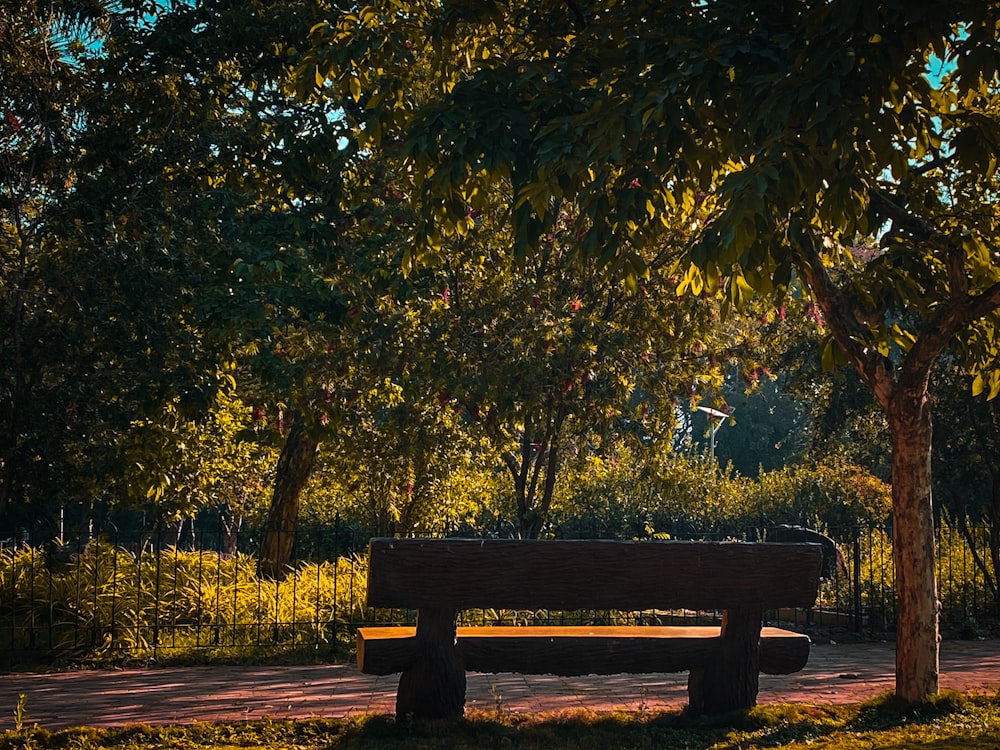 a wooden bench sitting in the middle of a park