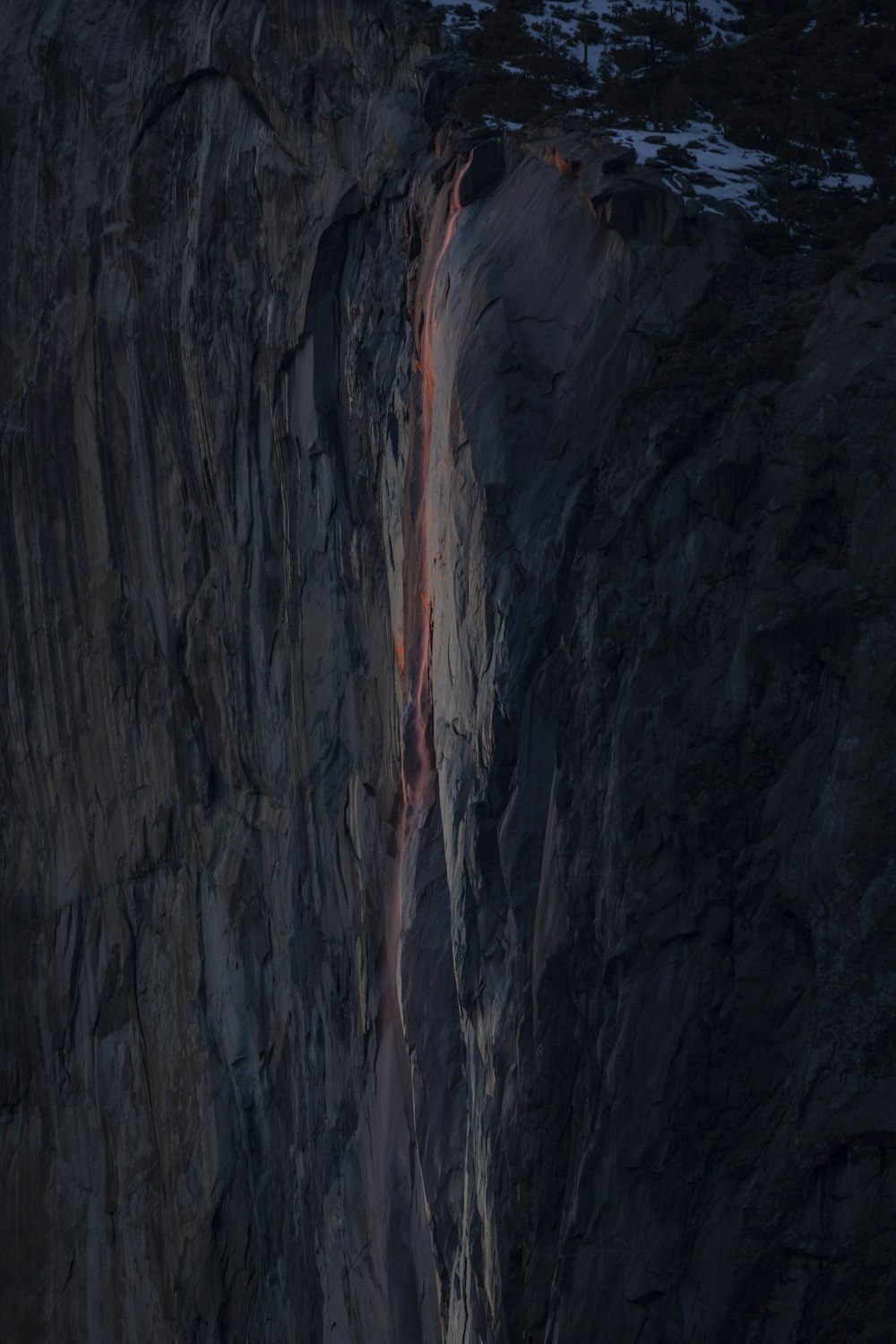 a man climbing up the side of a mountain