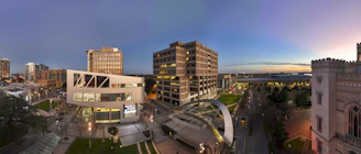 A panoramic cityscape at dusk showcasing modern infrastructure and glowing energy grids symbolizing global development.