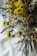 Close-up of a rustic bouquet of dried flowers on a wooden table.