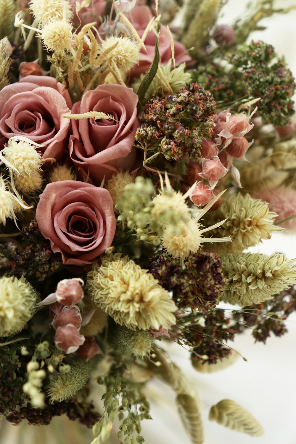 a bouquet of dried flowers in a vase