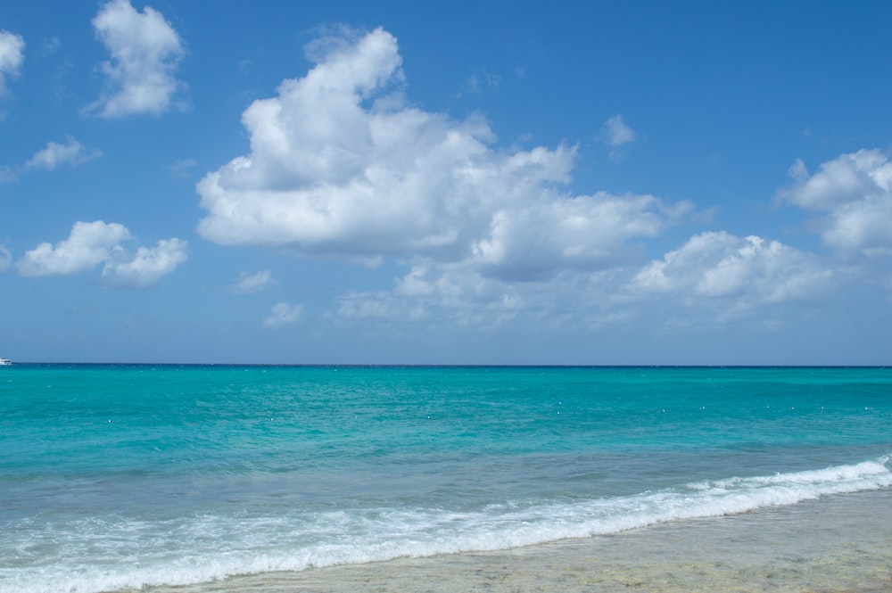 a boat is out in the ocean on a sunny day