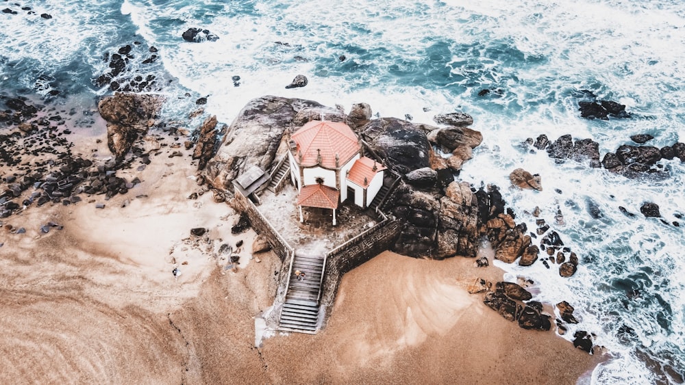 an aerial view of a house on the beach
