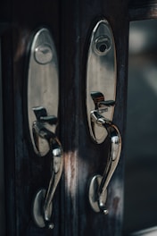 Elegant door handles displayed on a wooden board with soft lighting.
