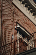 A residential front porch with discreet video surveillance cameras capturing the entrance.