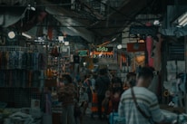 A friendly interpreter assisting a traveler with translation in a bustling market.